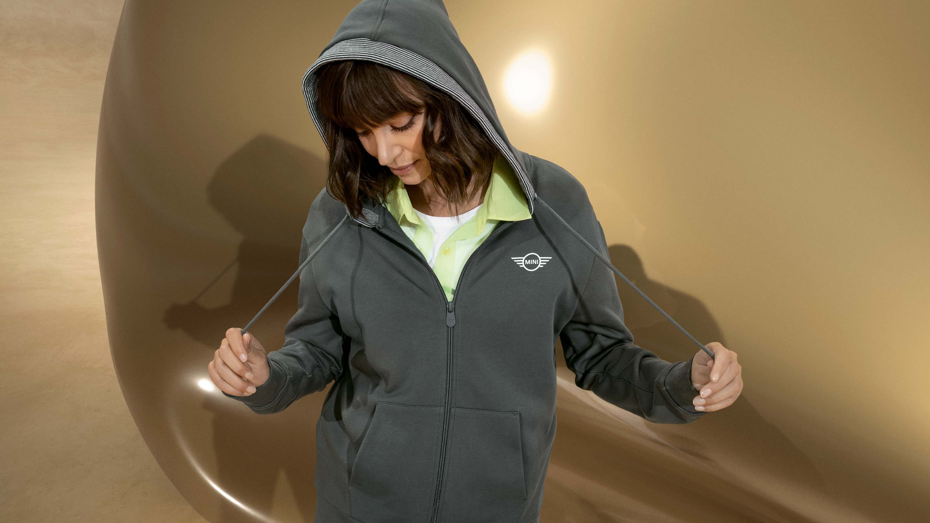 MINI Lifestyle - Brand T-Shits Logo  Guy opening a racetrack garage door with car displayed inside